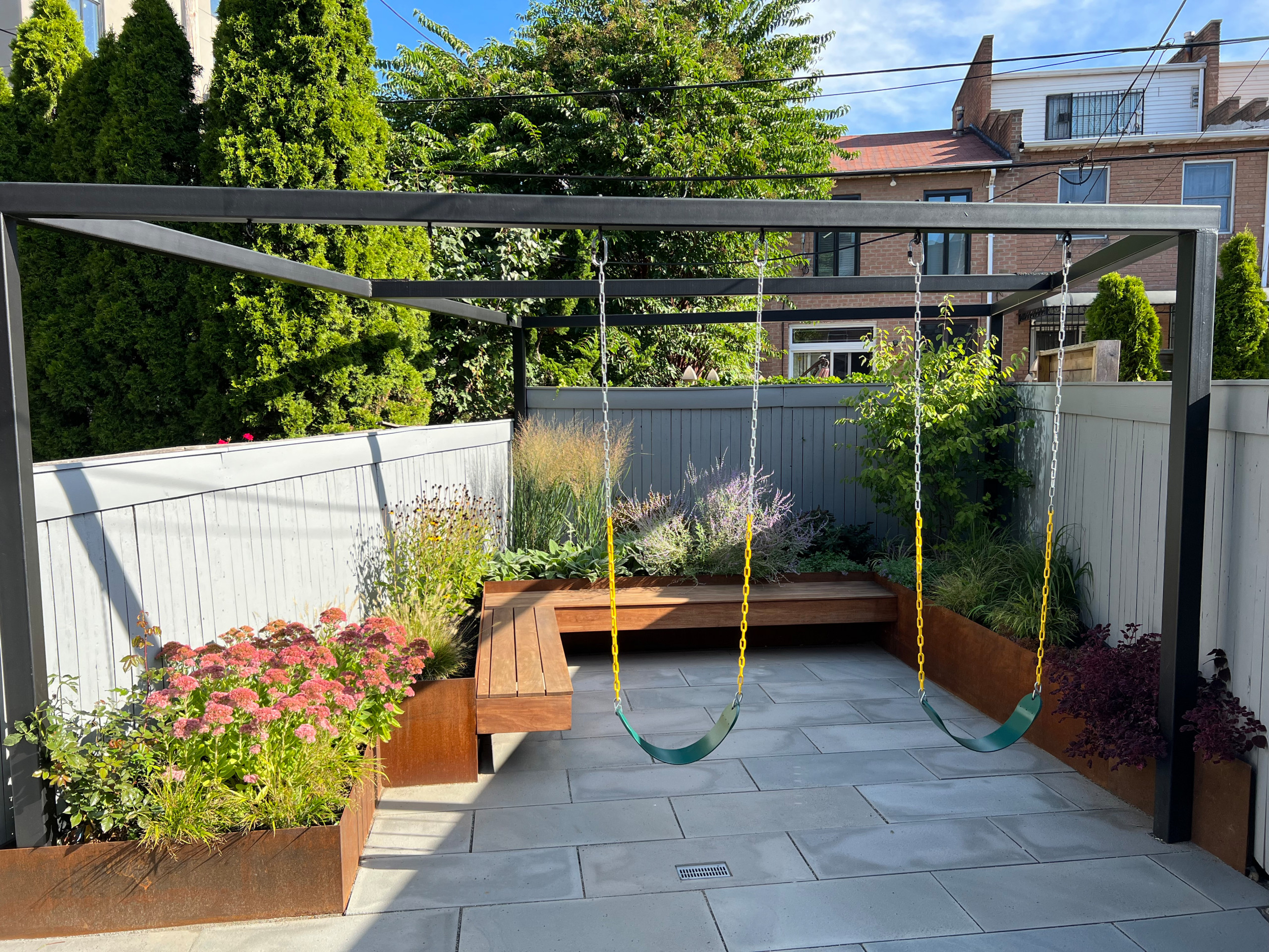 Paved patio with metal grating garden