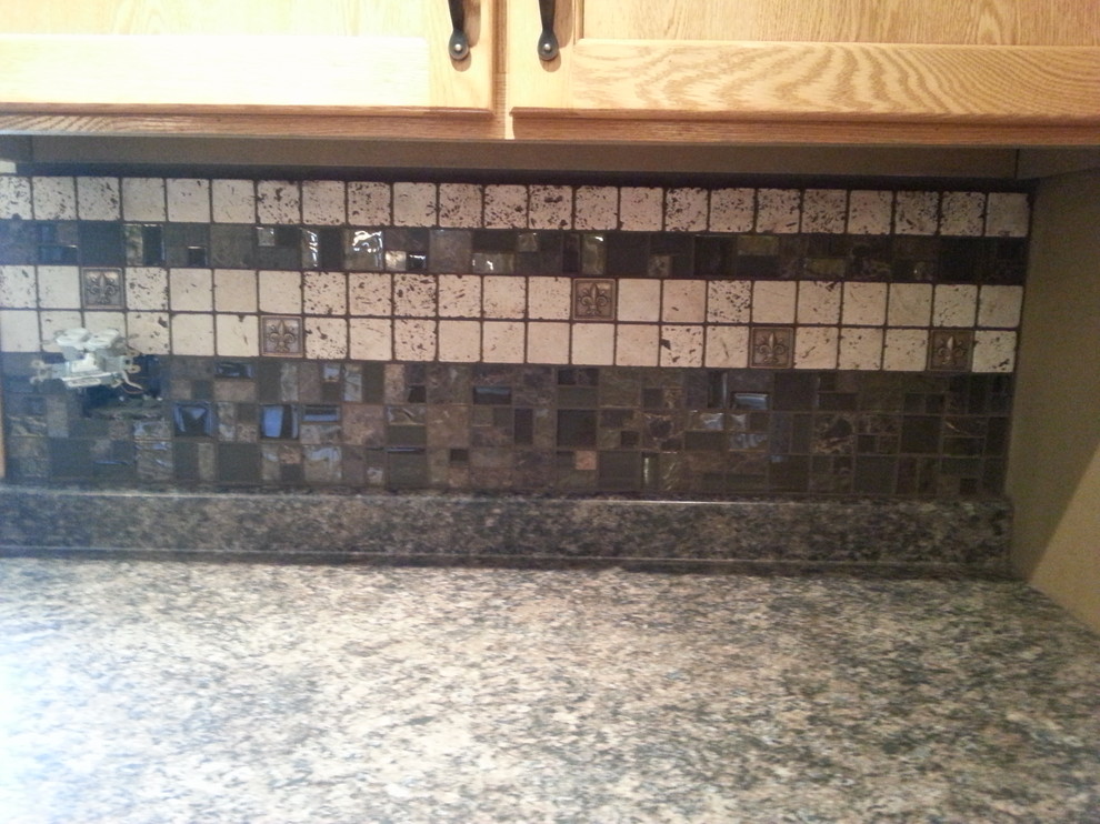 Example of a mountain style kitchen design with mosaic tile backsplash