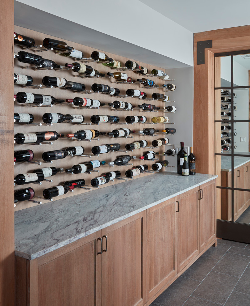Example of a transitional wine cellar design in Chicago with storage racks