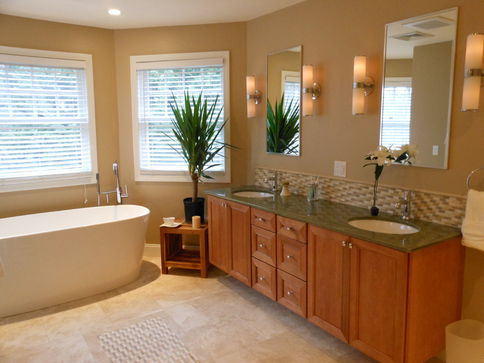 This is an example of a large transitional master bathroom in Boston with marble benchtops and a freestanding tub.