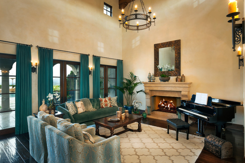 Mid-sized mediterranean open concept living room in Los Angeles with beige walls, dark hardwood floors, a standard fireplace, a stone fireplace surround and brown floor.