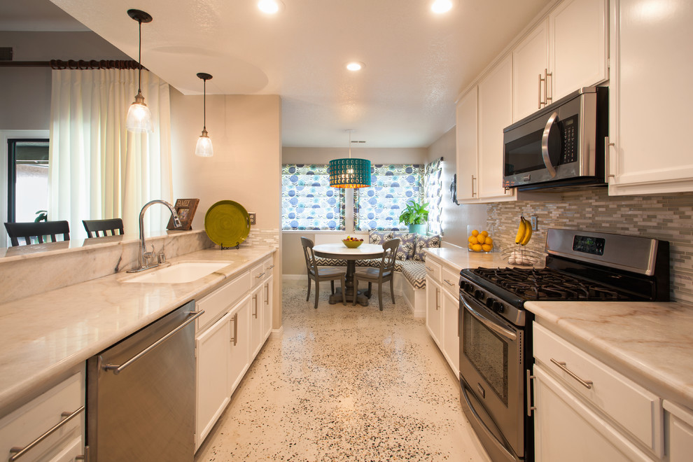 Inspiration for a mid-sized transitional kitchen remodel in Sacramento with flat-panel cabinets, white cabinets, granite countertops and glass tile backsplash