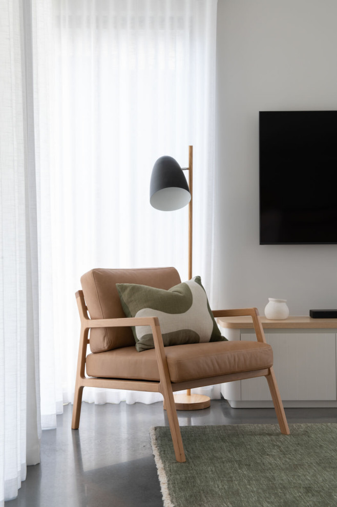Design ideas for a contemporary open concept living room in Perth with concrete floors and a wall-mounted tv.