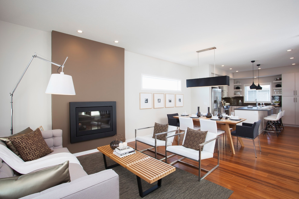 This is an example of a modern open concept living room in Calgary with brown walls and a standard fireplace.