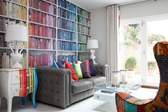 Photo of a large eclectic formal open concept living room in London with multi-coloured walls, a concealed tv, ceramic floors and white floor.