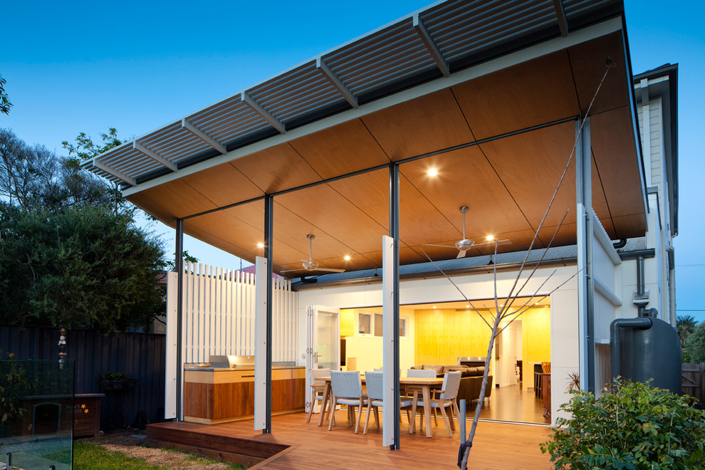 Photo of a contemporary backyard deck in Sydney with a roof extension.