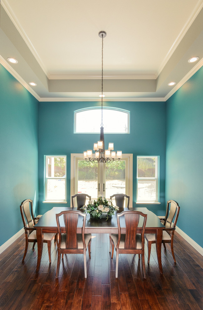 Photo of a mid-sized transitional dining room in San Francisco with blue walls and dark hardwood floors.