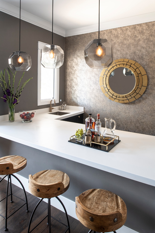 Small trendy l-shaped dark wood floor and brown floor seated home bar photo in Los Angeles with an undermount sink, quartz countertops and white countertops