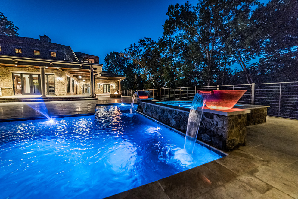 Large mountain style backyard tile and custom-shaped lap hot tub photo