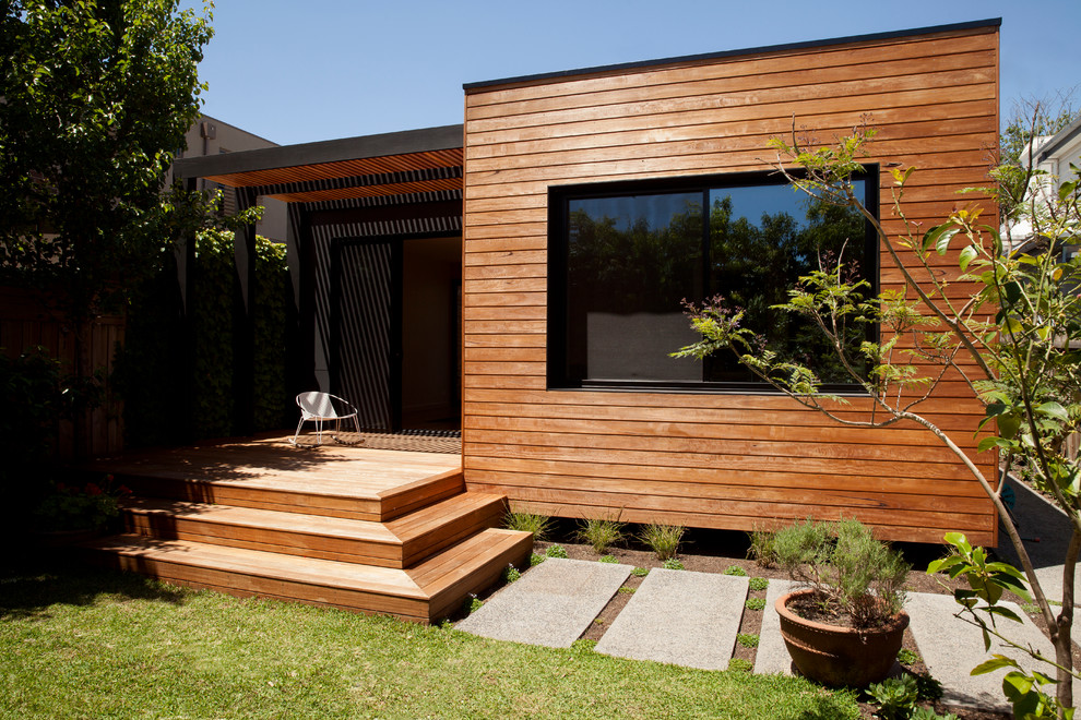 Contemporary one-storey brown exterior in Melbourne with wood siding and a flat roof.