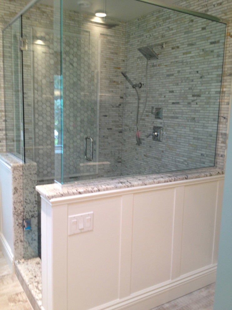 This is an example of a small traditional master bathroom in Detroit with shaker cabinets, beige cabinets, a freestanding tub, a corner shower, gray tile, marble, green walls, vinyl floors, a vessel sink, quartzite benchtops, grey floor, a hinged shower door and grey benchtops.