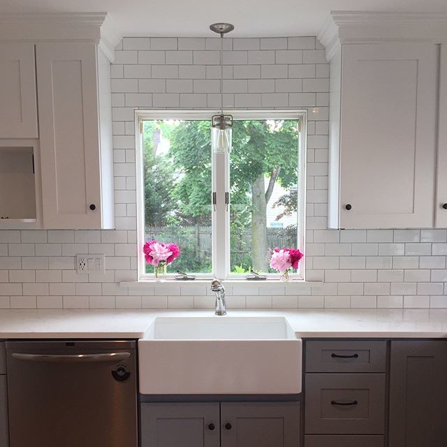 Inspiration for a small transitional kitchen remodel in Providence with a farmhouse sink, shaker cabinets, white cabinets, white backsplash, subway tile backsplash, white countertops and marble countertops