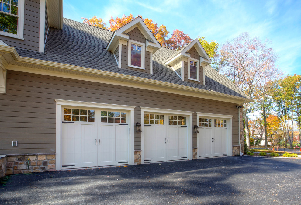 Photo of an expansive transitional attached three-car garage in New York.