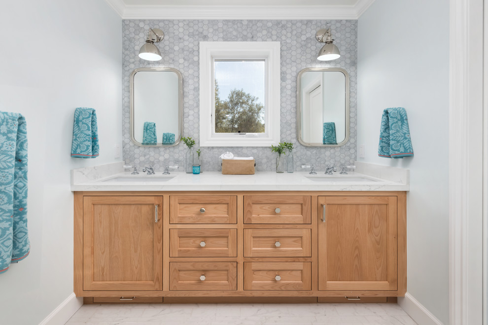 Inspiration for a large transitional 3/4 bathroom in San Francisco with beaded inset cabinets, light wood cabinets, an alcove shower, a one-piece toilet, gray tile, marble, blue walls, porcelain floors, an undermount sink, engineered quartz benchtops, grey floor, a hinged shower door and white benchtops.