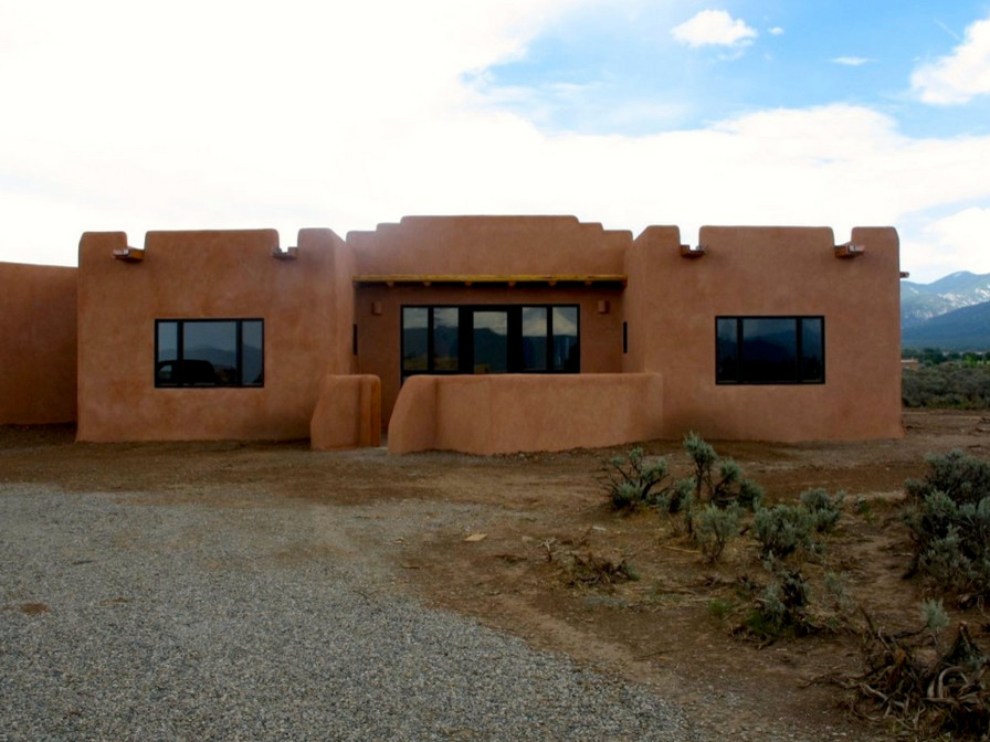 This is an example of a large contemporary one-storey concrete beige exterior in Albuquerque.
