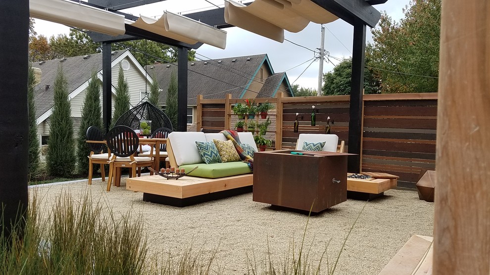 Photo of a small modern backyard patio in Kansas City with a fire feature, decomposed granite and a pergola.
