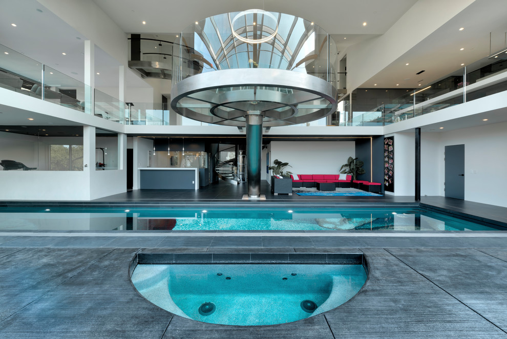 Photo of an expansive contemporary indoor rectangular lap pool in San Francisco with a hot tub and tile.
