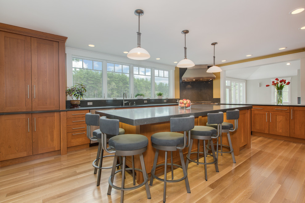 Transitional u-shaped medium tone wood floor kitchen photo in Boston with an undermount sink, shaker cabinets, medium tone wood cabinets, quartz countertops, gray backsplash, stone slab backsplash, stainless steel appliances and an island
