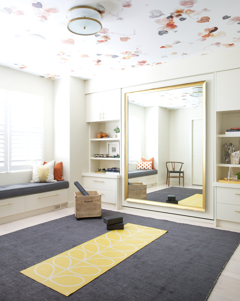 This is an example of a transitional home yoga studio in Calgary with beige walls and beige floor.