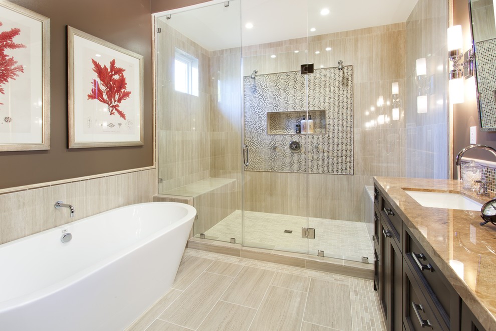 This is an example of a mid-sized mediterranean master bathroom in San Francisco with a freestanding tub, beige floor, recessed-panel cabinets, dark wood cabinets, an alcove shower, multi-coloured tile, mosaic tile, brown walls, porcelain floors, an undermount sink, granite benchtops, brown benchtops, a niche and a shower seat.