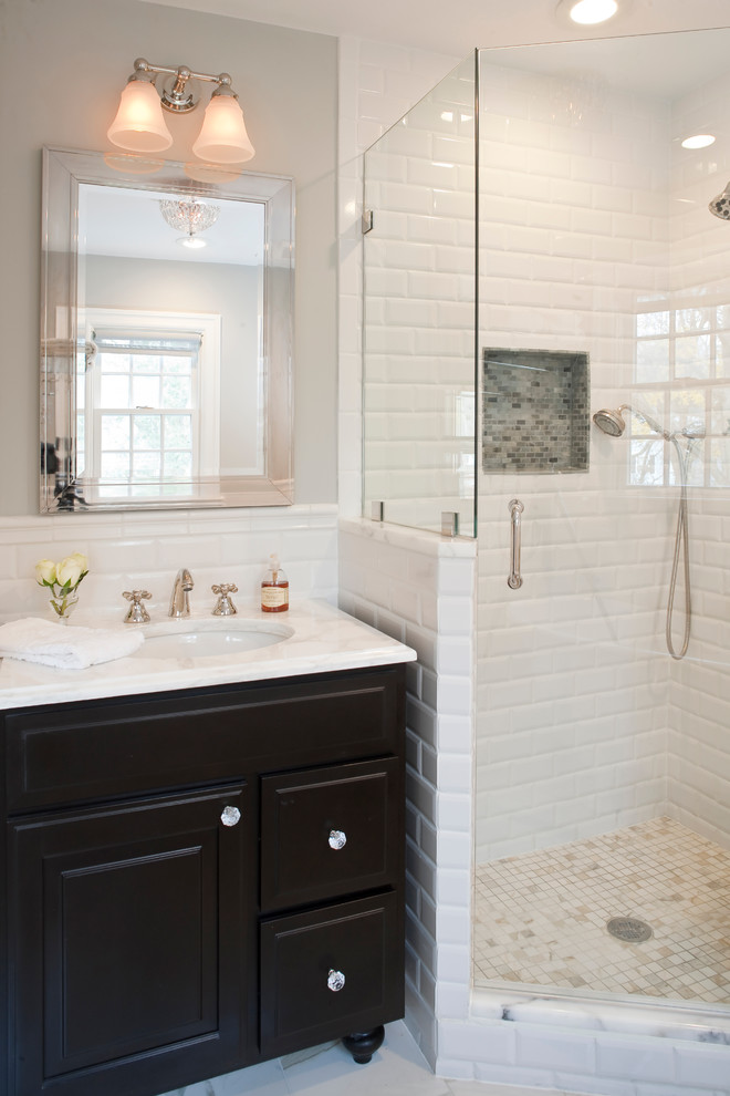 This is an example of a traditional bathroom in New York with a corner shower and an undermount sink.