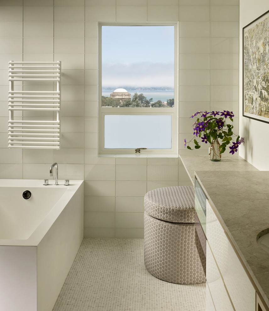 Inspiration for a mid-sized contemporary bathroom in San Francisco with flat-panel cabinets, white cabinets, gray tile, mosaic tile, granite benchtops, a one-piece toilet, white walls, mosaic tile floors and an undermount sink.