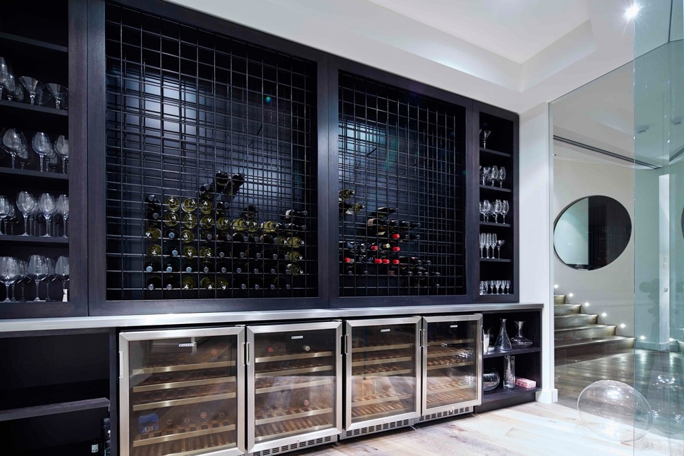 Contemporary wine cellar in Melbourne with storage racks and grey floor.