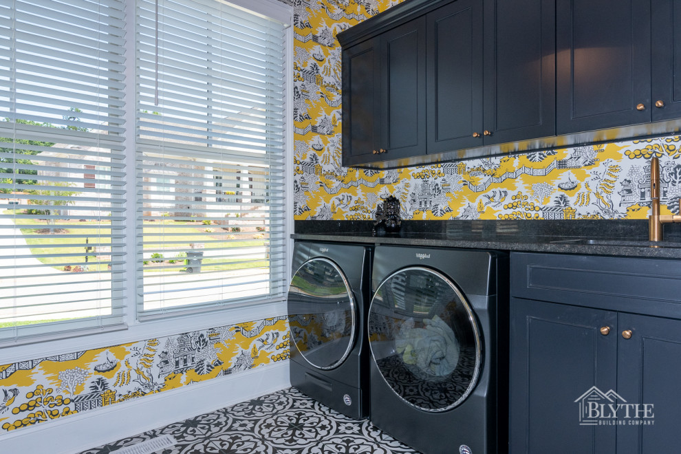 Inspiration for a large arts and crafts dedicated laundry room in Other with an undermount sink, recessed-panel cabinets, black cabinets, multi-coloured walls, ceramic floors, a side-by-side washer and dryer, multi-coloured floor, black benchtop and wallpaper.