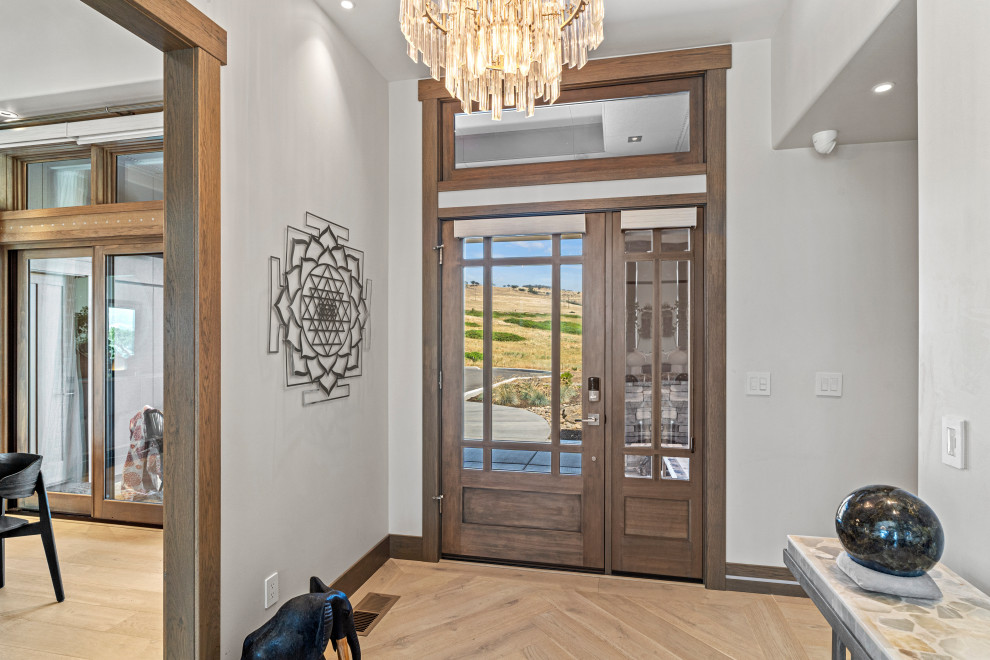 Foyer - mid-sized eclectic light wood floor and brown floor foyer idea with white walls and a medium wood front door