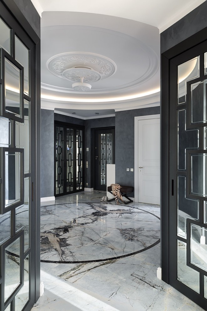 This is an example of a transitional foyer in Saint Petersburg with black walls, marble floors and grey floor.