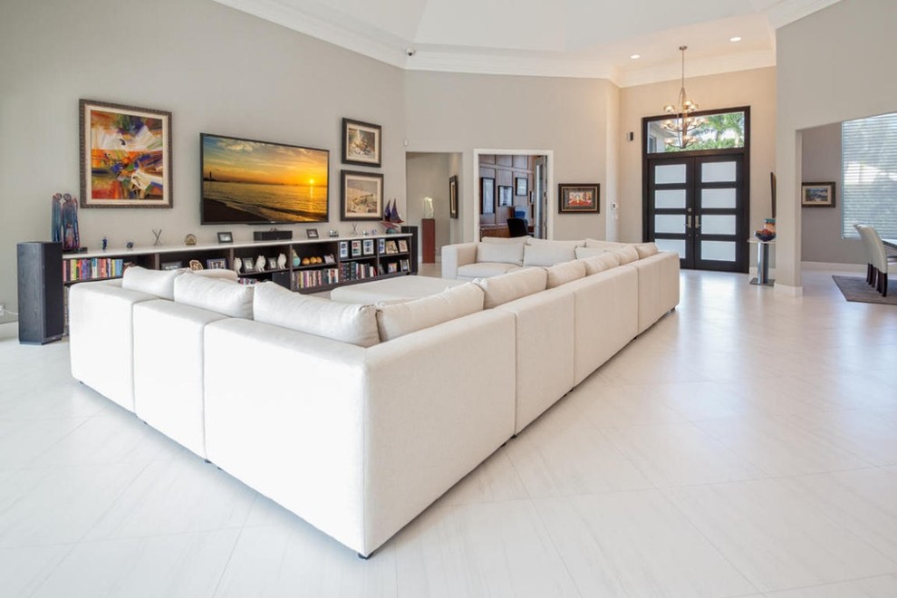 Large contemporary formal open concept living room in Miami with white walls and porcelain floors.