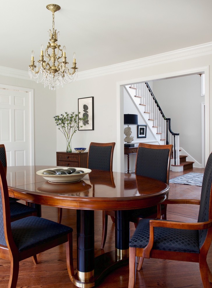 Mid-sized traditional separate dining room in New York with white walls, dark hardwood floors, no fireplace and brown floor.