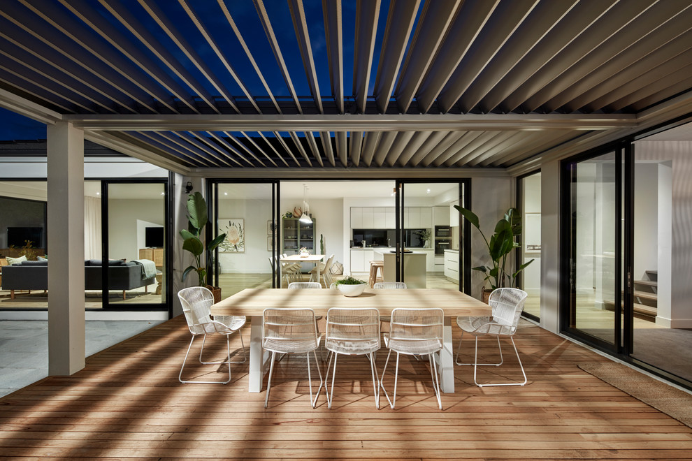 Photo of a contemporary backyard deck in Melbourne with a pergola.