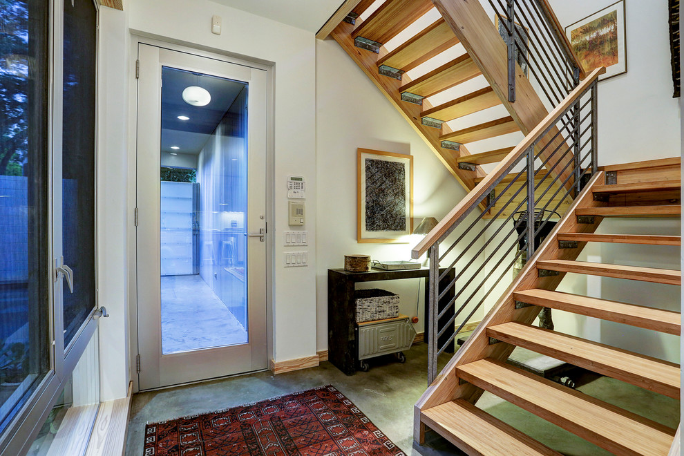 Design ideas for an industrial wood u-shaped staircase in Portland with open risers.