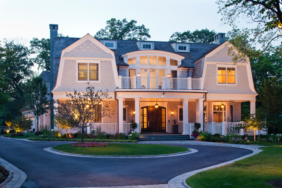 Inspiration for a large traditional two-storey grey exterior in Chicago with wood siding and a gambrel roof.