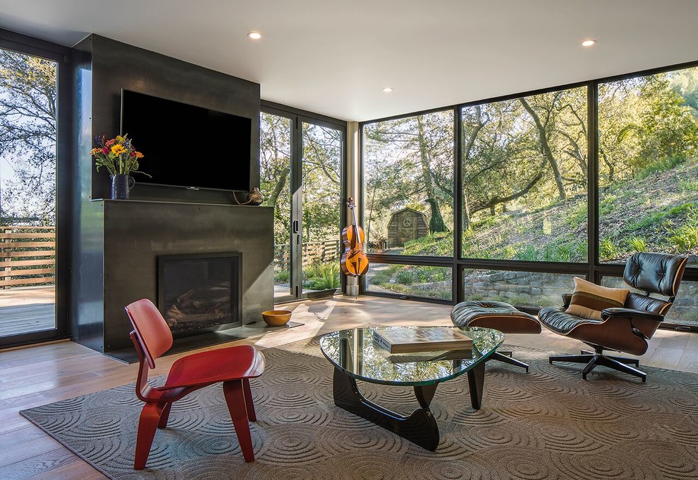 Large contemporary open concept living room in San Francisco with medium hardwood floors, a standard fireplace, a concrete fireplace surround and a wall-mounted tv.