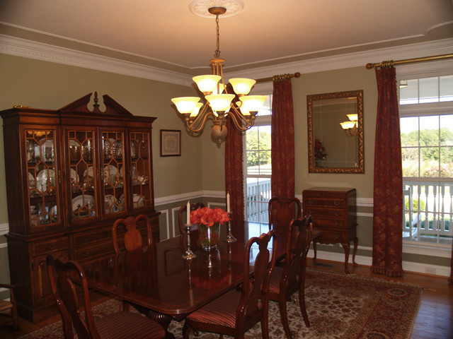 Mid-sized traditional separate dining room in DC Metro with green walls, medium hardwood floors and no fireplace.