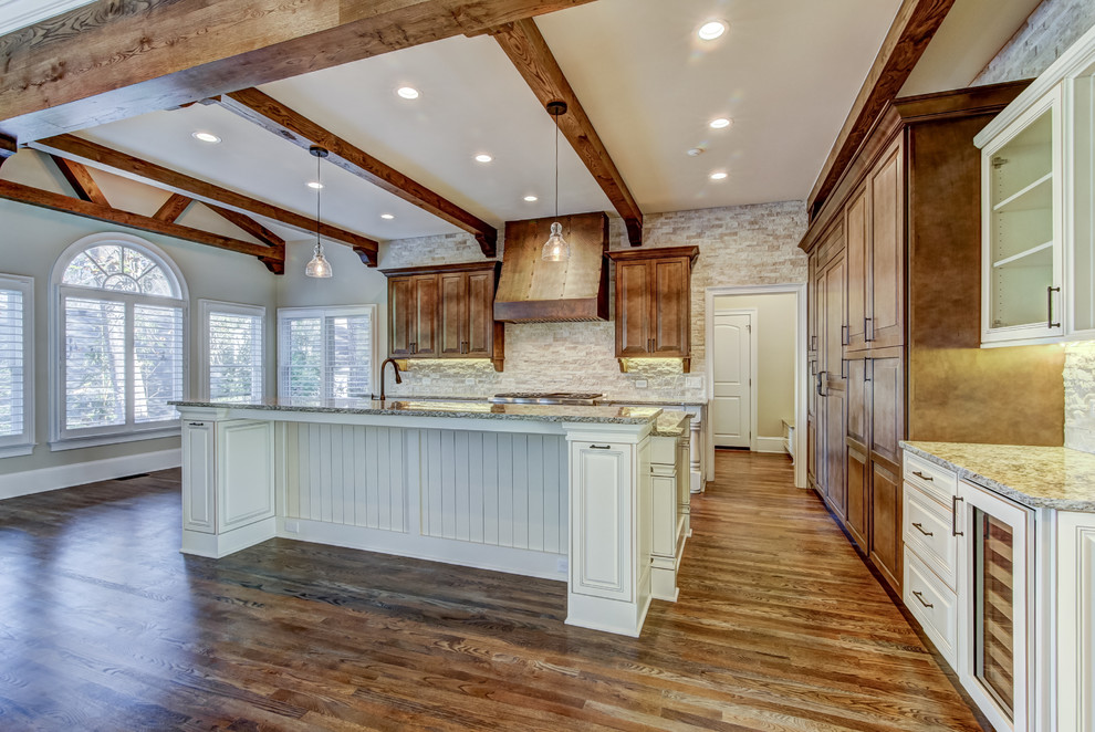 Example of a large mountain style single-wall medium tone wood floor and brown floor open concept kitchen design in Atlanta with raised-panel cabinets, white cabinets, granite countertops, beige backsplash, brick backsplash, stainless steel appliances, an island and a farmhouse sink