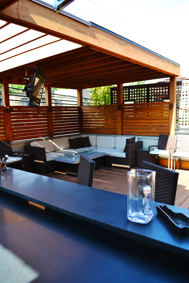 Inspiration for a mid-sized transitional rooftop outdoor kitchen deck remodel in Chicago with decking and a roof extension