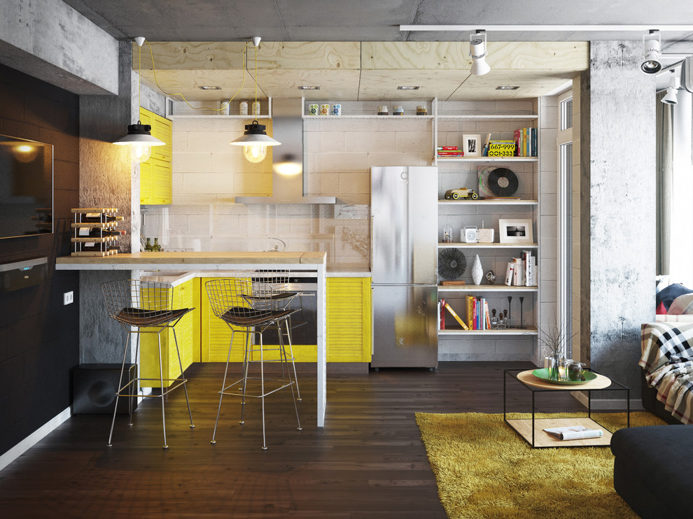 Design ideas for a small industrial open plan kitchen in Other with an integrated sink, yellow cabinets, black splashback, glass sheet splashback, panelled appliances, with island and dark hardwood floors.