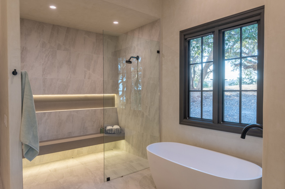 This is an example of an expansive master bathroom in Other with a freestanding tub, a curbless shower, multi-coloured tile, beige walls, an undermount sink, multi-coloured floor, an open shower, beige benchtops, a shower seat and a double vanity.