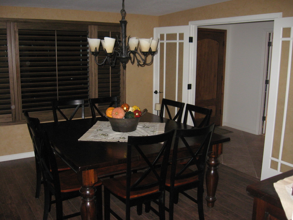 Inspiration for a mid-sized rustic dark wood floor enclosed dining room remodel in Phoenix with beige walls, a standard fireplace and a stone fireplace