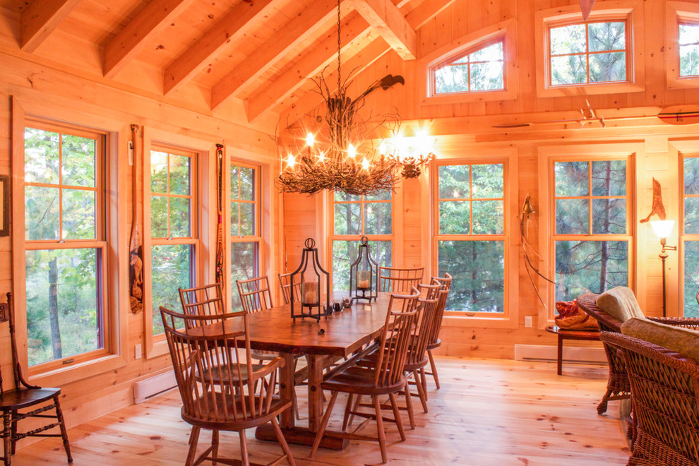 Design ideas for a large country dining room in Other with light hardwood floors and no fireplace.