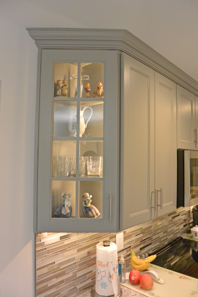 Example of a small transitional u-shaped vinyl floor and brown floor eat-in kitchen design in DC Metro with an undermount sink, shaker cabinets, gray cabinets, granite countertops, gray backsplash, mosaic tile backsplash, stainless steel appliances, a peninsula and gray countertops