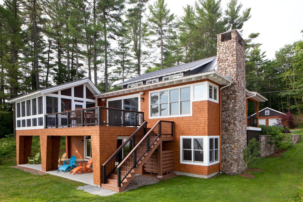 This is an example of a large beach style brown exterior in Portland Maine with wood siding.