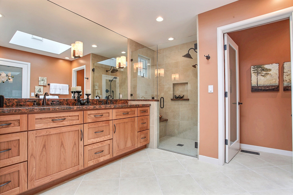 This is an example of a mid-sized transitional master bathroom in San Francisco with an undermount sink, granite benchtops, a one-piece toilet, beige tile, porcelain tile, orange walls, porcelain floors, medium wood cabinets, shaker cabinets, an alcove shower, beige floor, a hinged shower door and multi-coloured benchtops.
