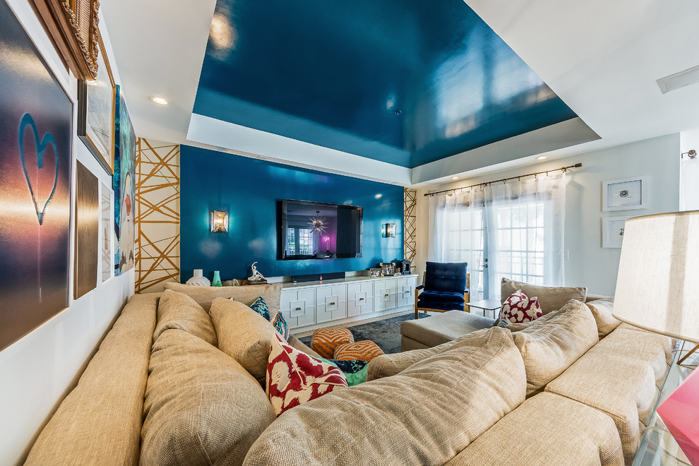 Inspiration for a mid-sized eclectic enclosed family room in Miami with blue walls, ceramic floors, no fireplace and a wall-mounted tv.