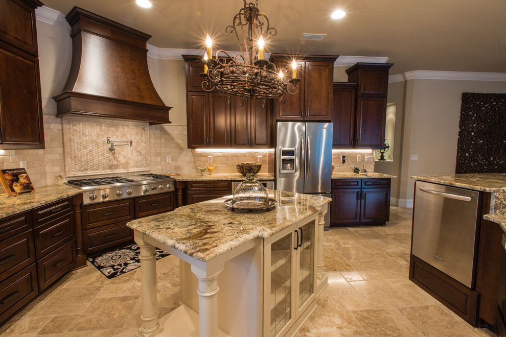 Inspiration for a large transitional l-shaped separate kitchen in Orlando with an undermount sink, raised-panel cabinets, dark wood cabinets, granite benchtops, beige splashback, mosaic tile splashback, stainless steel appliances, travertine floors, with island and beige floor.