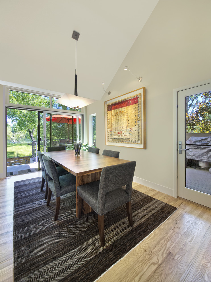 Kitchen/dining room combo - mid-sized mid-century modern light wood floor kitchen/dining room combo idea in Denver with beige walls and no fireplace