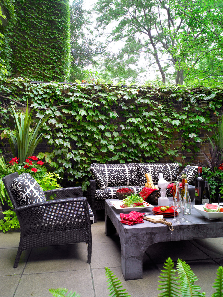Eclectic patio in Toronto with no cover.